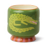 Bougie A Dopo Prickly Pear Paddywax avec motif crocodile et pot en céramique colorée.